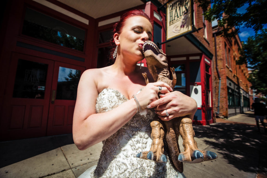 Bride with dinosaur - dinosaur themed wedding - quad cities wedding photographer